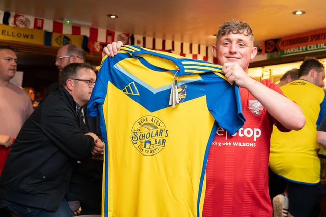 A Boro supporter shows off his new away shirt.