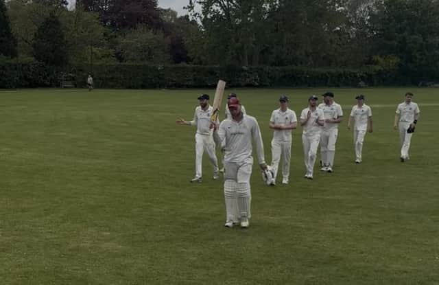Pocklington CC batsman Dan Littlewood holds his bat aloft after his 91 not out for the first team on Saturday.