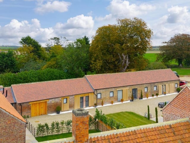 An exterior view of the property and its rural surroundings.