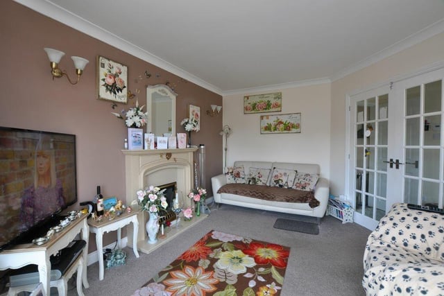 The bright lounge has a feature fireplace with living flame gas fire.