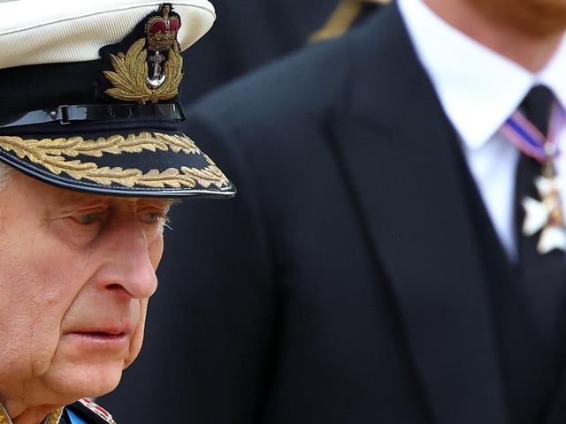 King Charles III follows a Bearer Party of The Queen's Company, 1st Battalion Grenadier Guards carrying the coffin of Queen Elizabeth II outside Westminster Abbey. (Photo by HANNAH MCKAY / POOL / AFP) (Photo by HANNAH MCKAY/POOL/AFP via Getty Images)