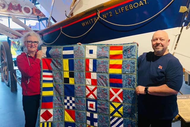 Lu McCaskill presents her hand-made quilt to Friends Of Whitby Lifeboat. picture: Ceri Oakes