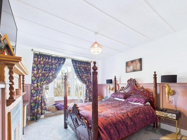 A double bedroom with period fireplace as a charming feature.