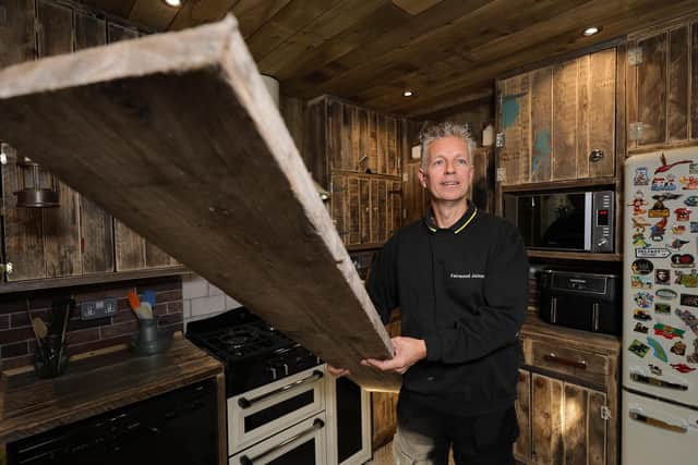 Old scaffold boards were cleaned up and sanded down to make the kitchen cabinets