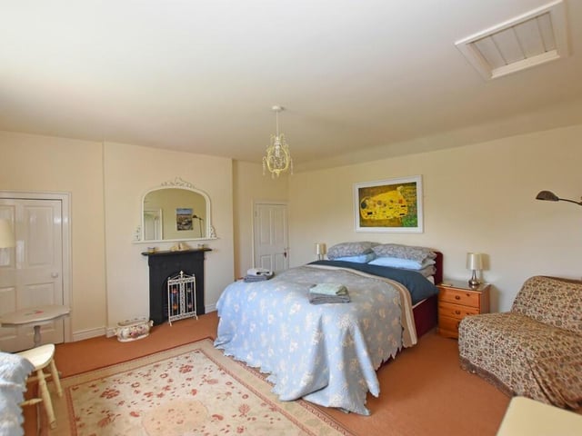 One of three bedrooms in the cottage. This one has a charming period fireplace.