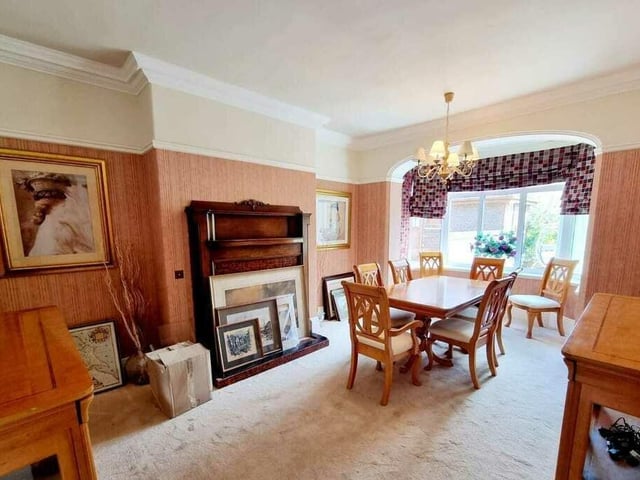 This dining, or second reception room has a bay window admitting plenty of natural light, and a feature fireplace.