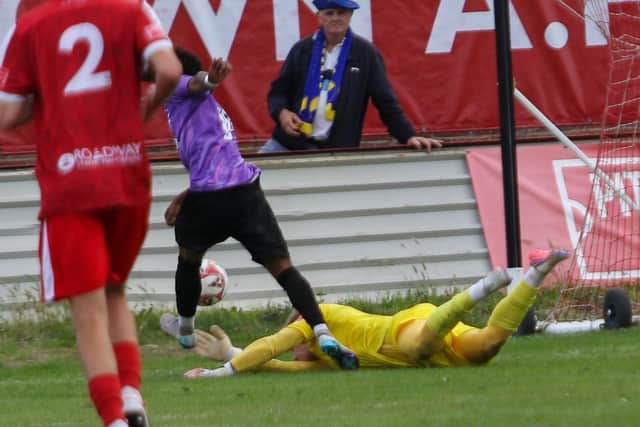 Bridlington Town goalkeeper Alex Baird makes a fine lave save to stop Garforth forward Mutty. Photo by Rhys O'Callaghan