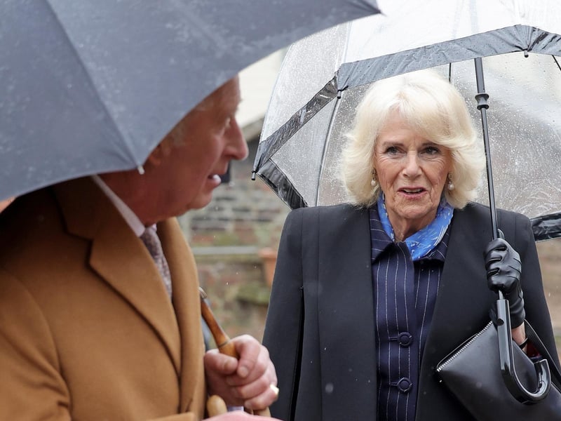 Camilla, the Queen Consort, looked lovely in a navy blue camel jacket.