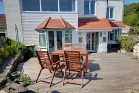 A decked seating area catches the sun.