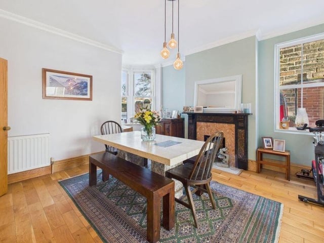 The dining room has versatile space, with a charming fireplace.