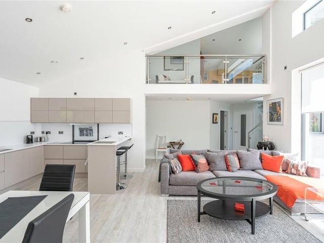 An overview of the ground floor open plan arrangement with first floor mezzanine above.