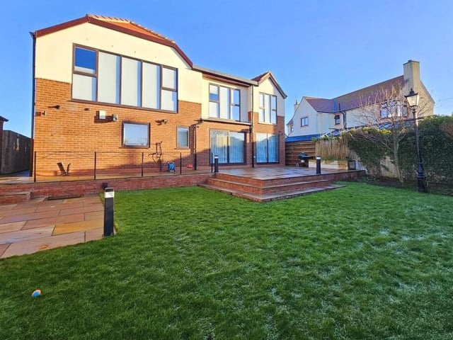 A rear view of the house, from its lawned garden.