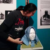 Whitby Museum Assistant Emma Gates preparing a Staithes Bonnet for the Our Lasses exhibition.