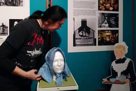 Whitby Museum Assistant Emma Gates preparing a Staithes Bonnet for the Our Lasses exhibition.