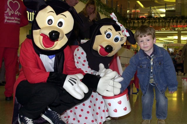 Mickey Mouse and Minnie were raising money for the British Heart Foundation by collecting money in Doncaster's Frenchgate Centre. Our picture shows four year-old Jordan Vaughan, of Kirk Sandall, put a contributon in their bucket.