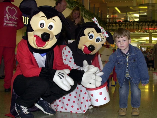 Mickey Mouse and Minnie were raising money for the British Heart Foundation by collecting money in Doncaster's Frenchgate Centre. Our picture shows four year-old Jordan Vaughan, of Kirk Sandall, put a contributon in their bucket.