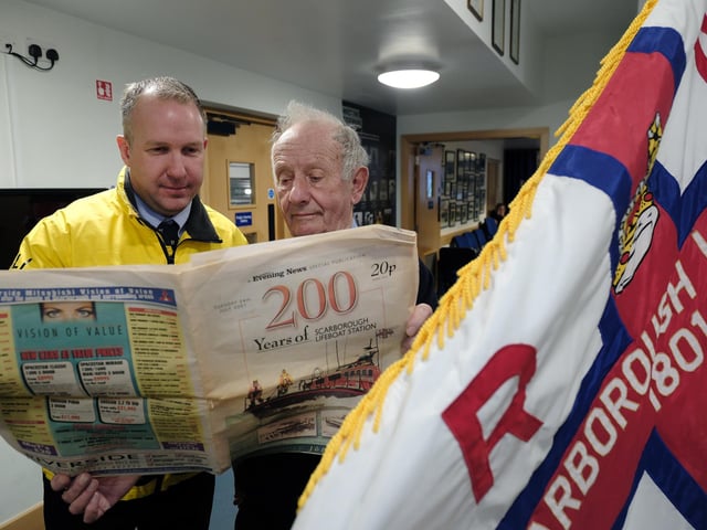 Reading a commemorative issue of The Scarborough News