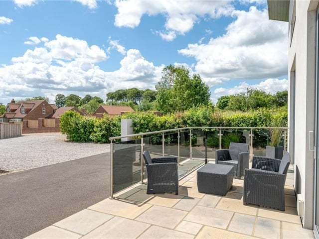 An outdoor patio area, with glass balustrade.