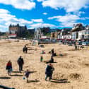 A few visitors to Scarborough enjoying the bright sunny Spring Day by walking and playing with their families on the beach during the start of the Easter Holidays. Picture By Yorkshire Post Photographer,  James Hardisty. Date: 3rd April 2023.