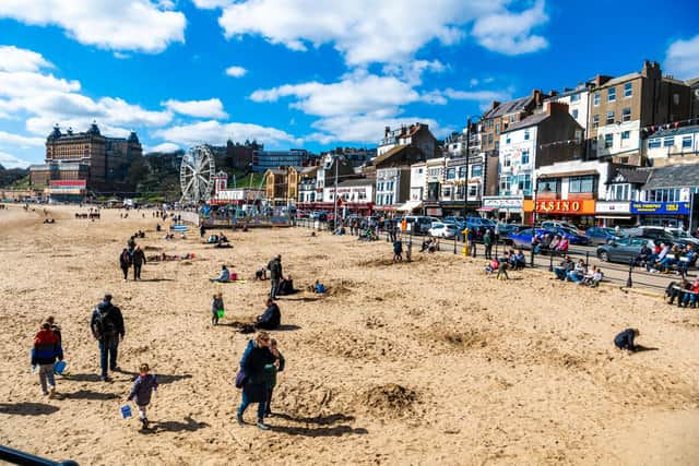 A few visitors to Scarborough enjoying the bright sunny Spring Day by walking and playing with their families on the beach during the start of the Easter Holidays. Picture By Yorkshire Post Photographer,  James Hardisty. Date: 3rd April 2023.