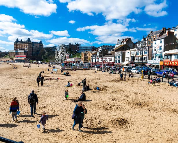 A few visitors to Scarborough enjoying the bright sunny Spring Day by walking and playing with their families on the beach during the start of the Easter Holidays. Picture By Yorkshire Post Photographer,  James Hardisty. Date: 3rd April 2023.