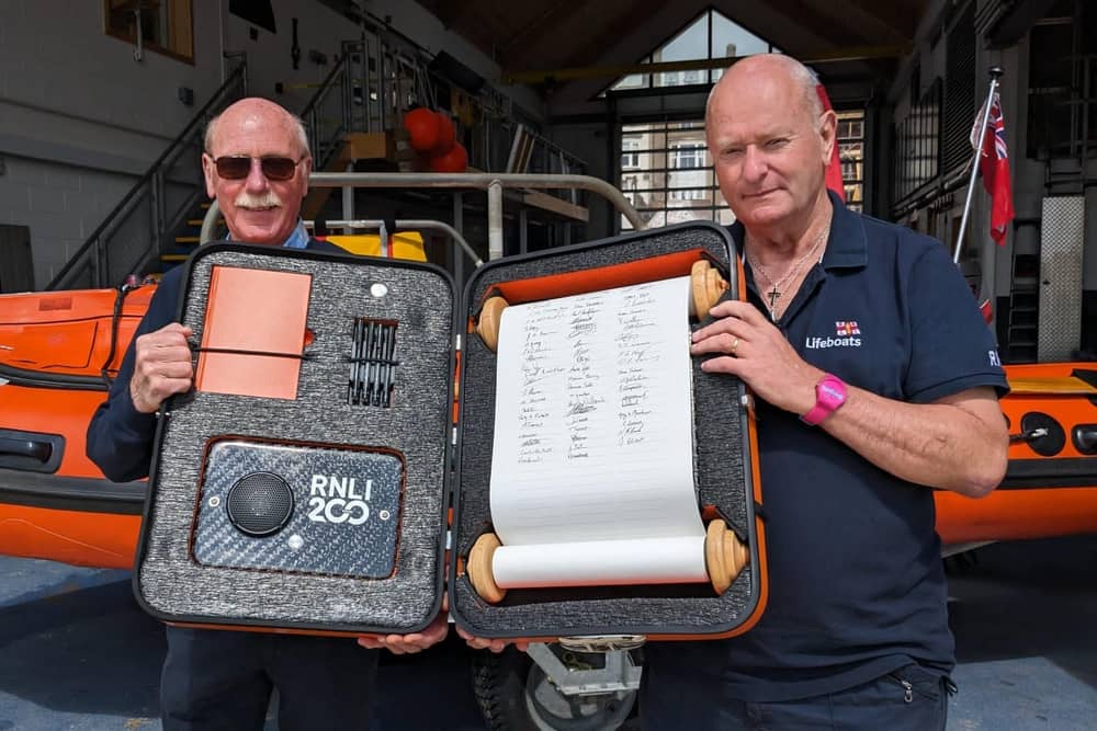 Colin Woodhead and Roger Buxton after signing the scroll. Image: RNLI/Laura Lyth
