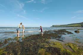 Visitors paddling on the beach at Robin Hood's Bay.picture: Trevor Hart