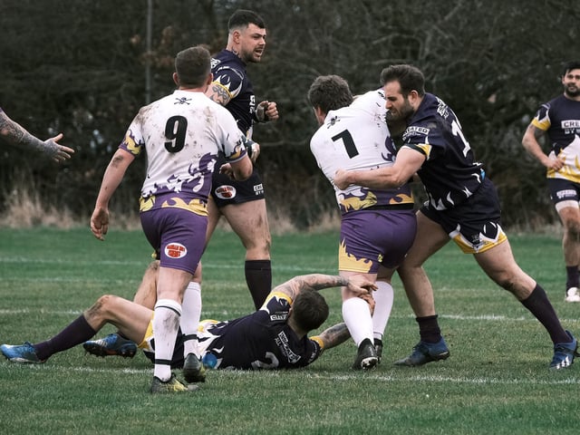 The players get stuck in during the warm-up match