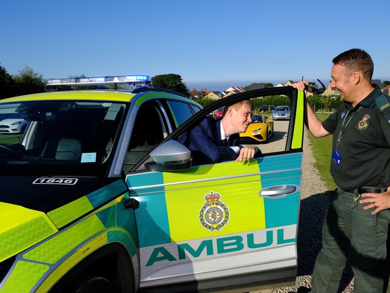 An Ambulance Emergency vehicle drops off one of the prom-goers.