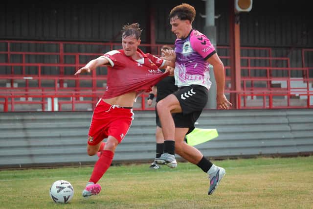 Former Brid Town player Stan Hewitt gets to grip with former teammate Casey Stewart during Friday's 2-2 draw at Queensgate. Photo by EC Media