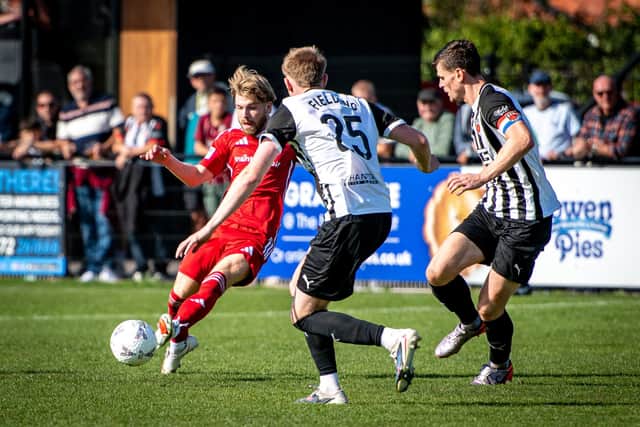 Chorley players close in on Luke Hall. Photo by Ben Gordon