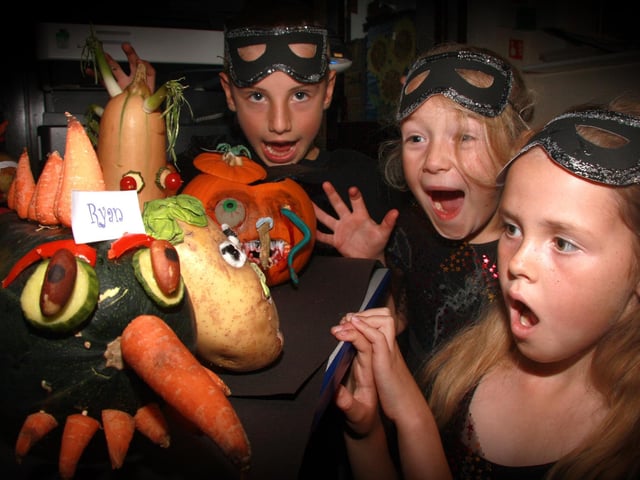 Pupils from Seton School make scary monsters from fruit and vegetables for their harvest festival (2009).