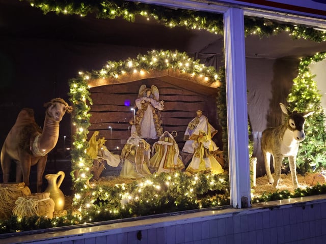 A golden nativity scene in the store's window