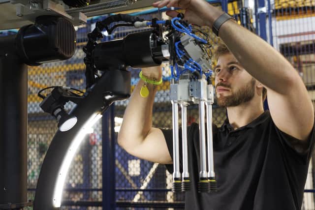 Mitchell McDonald, Robotics Engineer 1, working on the Prototype Robotics code name BlueJay at the Amazon facilities in Westborough, Massachusetts.