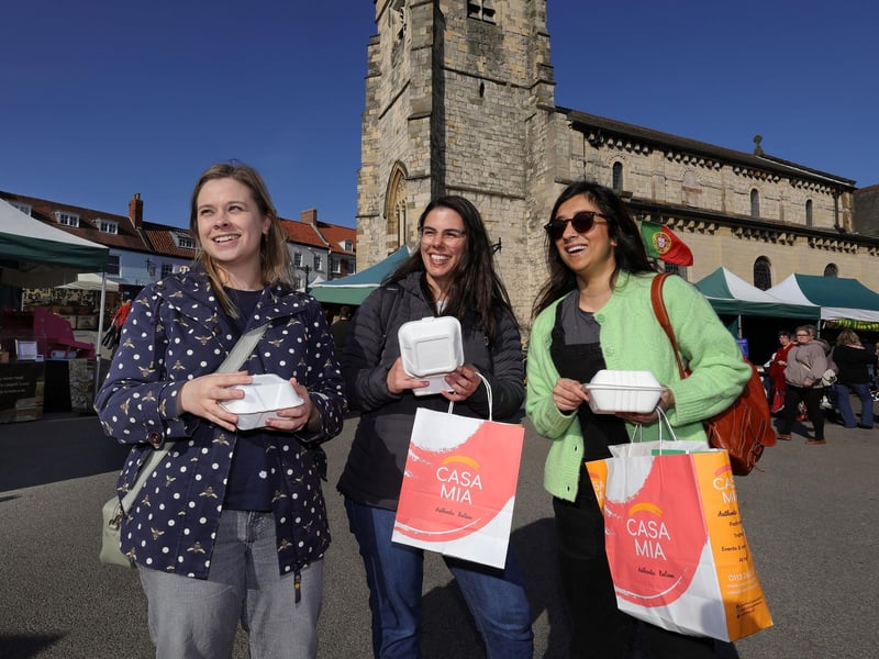 This trio enjoy some of the market goodies.