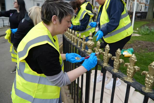 Volunteers paints railings as part of a scheme run by North Yorkshire Council to improve areas of Scarborough.
