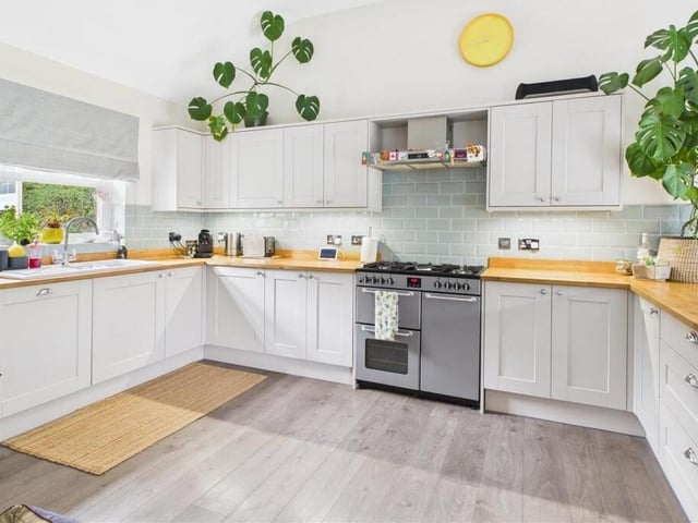 The kitchen has fitted units with oak work surfaces, and integrated appliances.