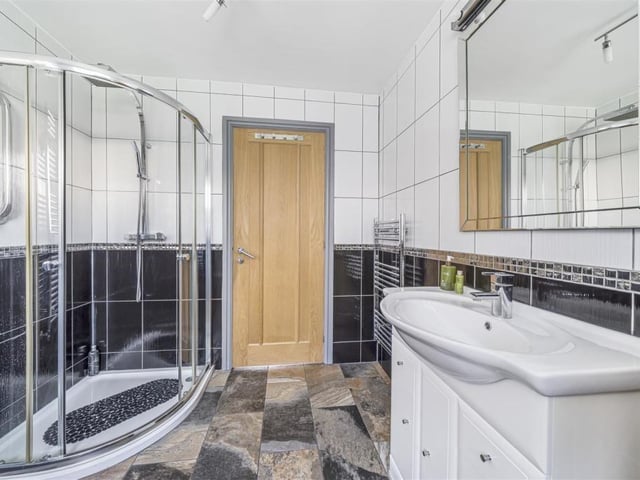 A modern shower room facility within the property.