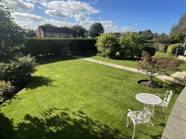 A mature lawned garden with open views.