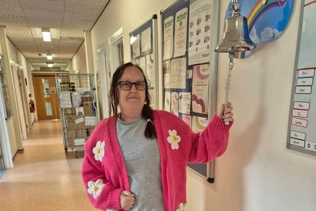 Joanne Fawthrop, Unit Lead at Castle Grange Care Home, rings the bell after completing chemotherapy treatment.
