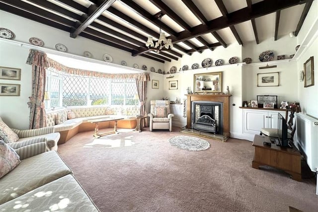 The lounge has a large bay window with curved window seat.