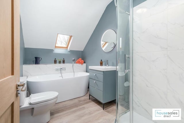 A modern bathroom with freestanding bath and a separate shower unit.