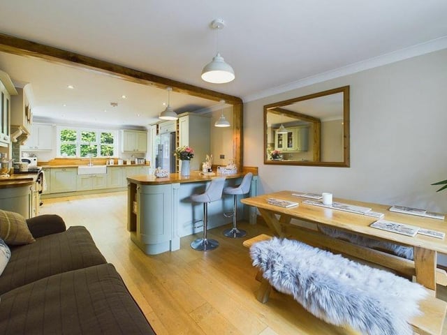 A modern, open plan interior with breakfast bar and additional dining area.