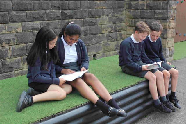 Pupils from Morley Victoria School reading the book Move Well.
