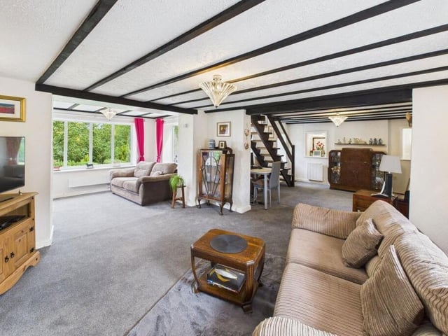 The spacious beamed interior of the three-bedroom cottage.