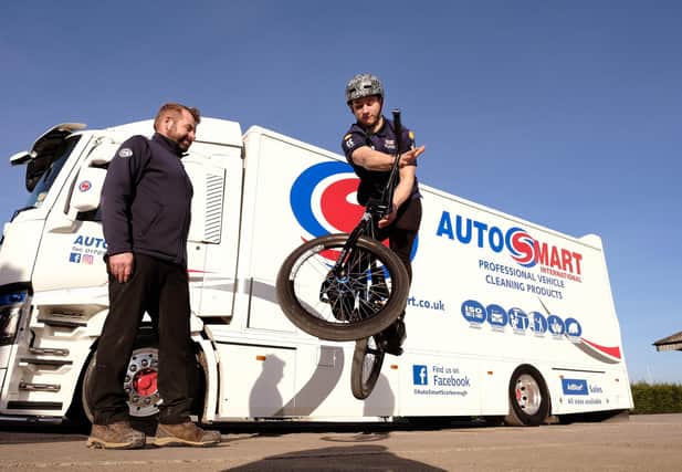 Auto Smart sponsor...Paul Daley - Smith looks on as BMX star Miller Temple shows off a bike jump