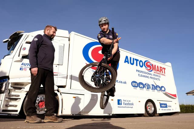 Auto Smart sponsor...Paul Daley - Smith looks on as BMX star Miller Temple shows off a bike jump