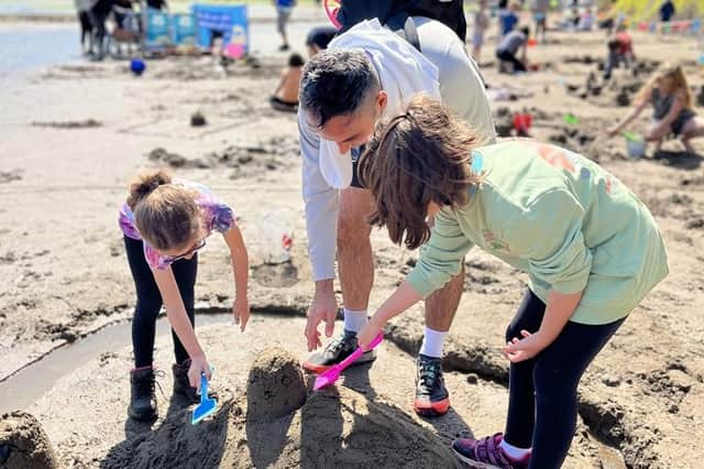 Families enjoy a sandcastle competition on the beach. Photo: Andrew Davies/NT