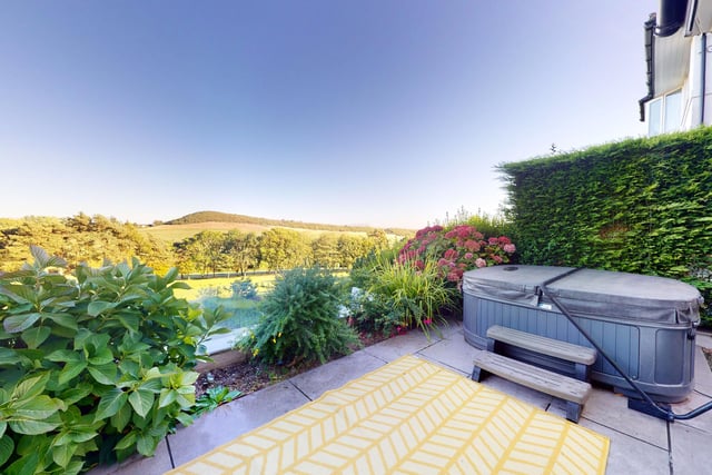 From this elevated patio, the hot tub is in a great spot for occupants to enjoy the scenery.