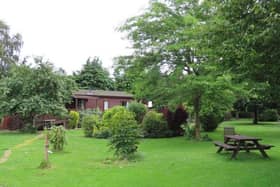One of the lodges for sale on the site, and its leafy surroundings.